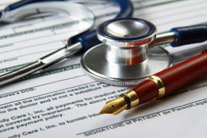 Stethoscope on medical billing statement on table, all text is a